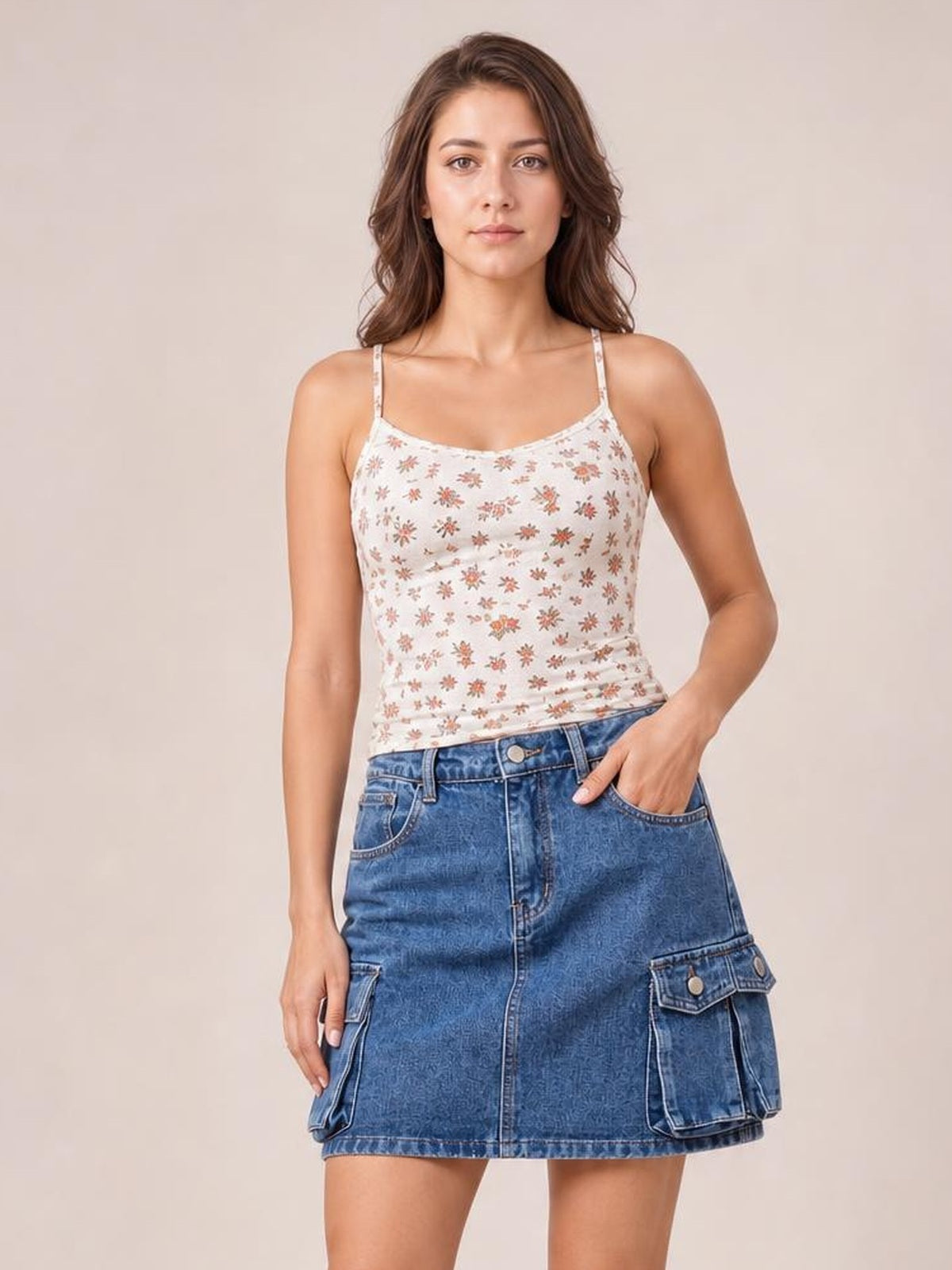 A model poses in a blue high waist denim skirt with a straight mini silhouette, front button closure, belt loops, stitched seams, and flap cargo pockets.
