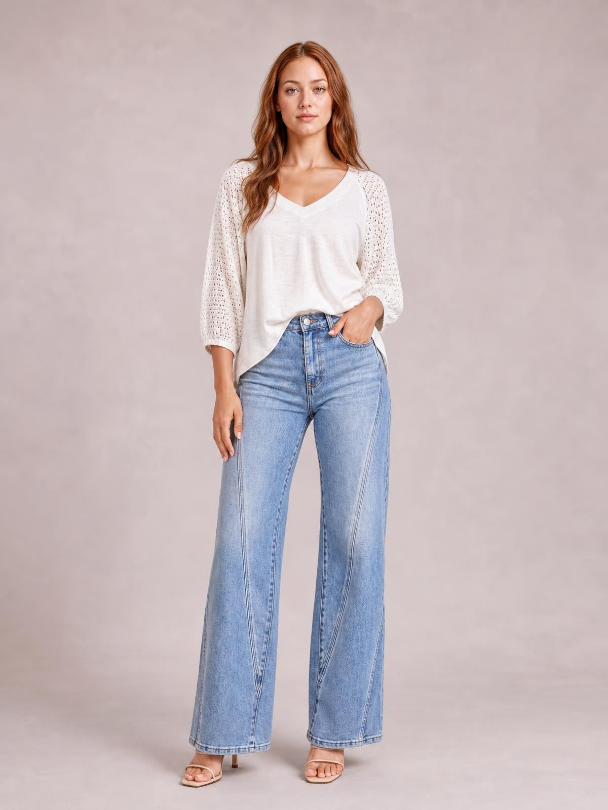 Model wearing light-wash high-waisted straight-leg jeans with front and side pockets, a button fly, and full-length structured legs.
