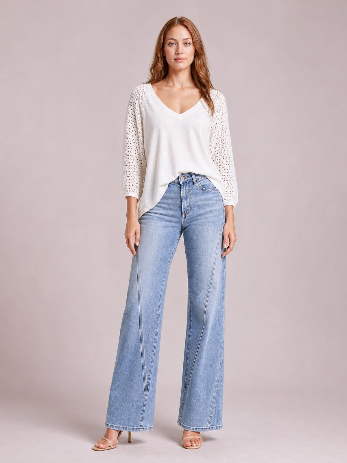 A model stands facing forward in light-wash high-waist straight jeans with front pockets, belt loops, button closure, and full-length legs.