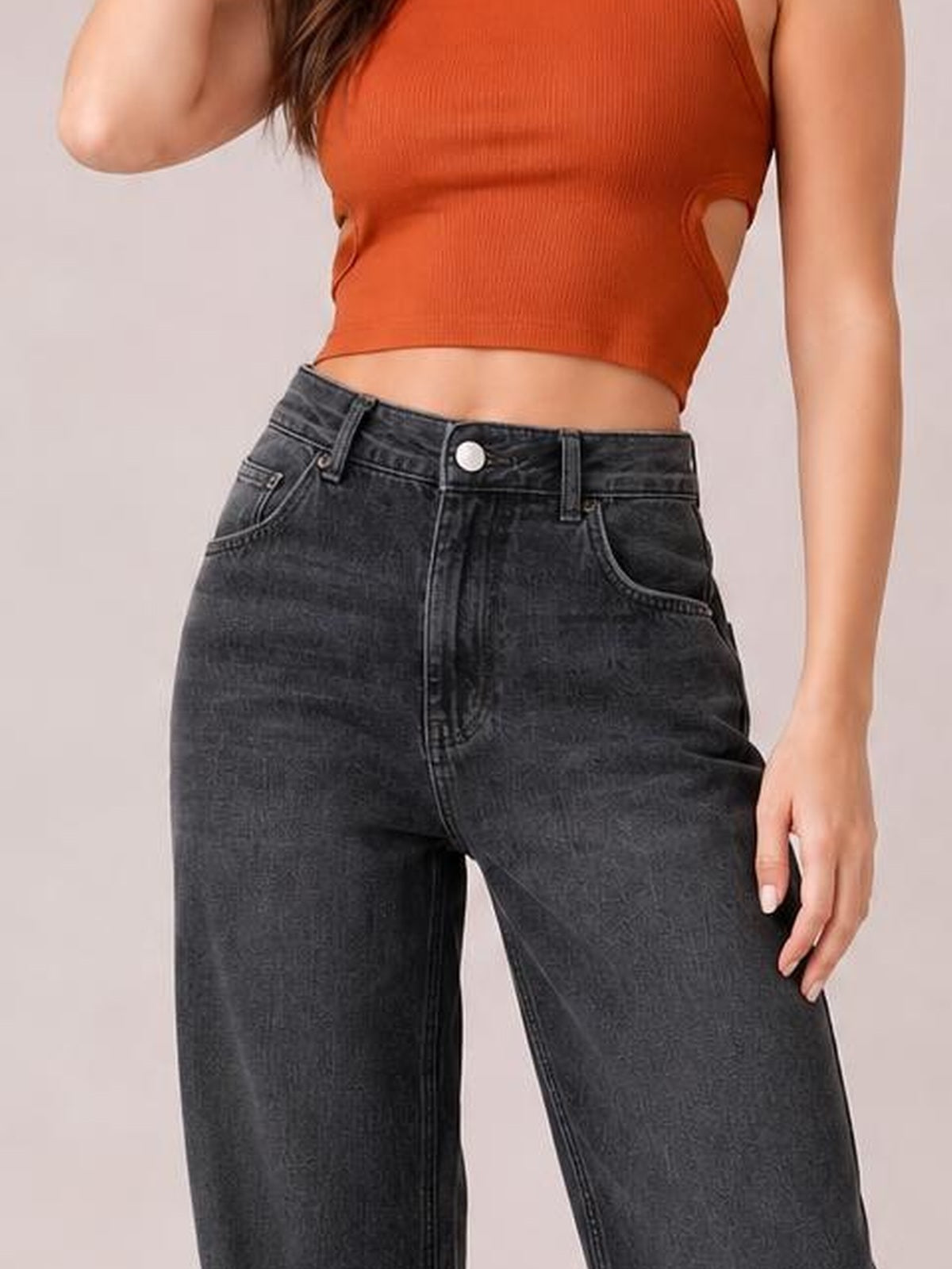 Model wearing charcoal high-waist wide-leg jeans with a button closure, belt loops, front pockets, and visible seam detailing.