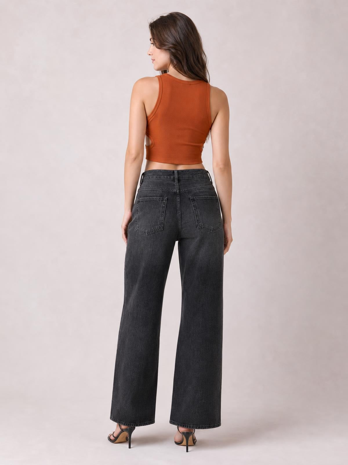 Model shown from behind wearing high waist charcoal wide leg jeans with a buttoned waistband, belt loops, and two back pockets.