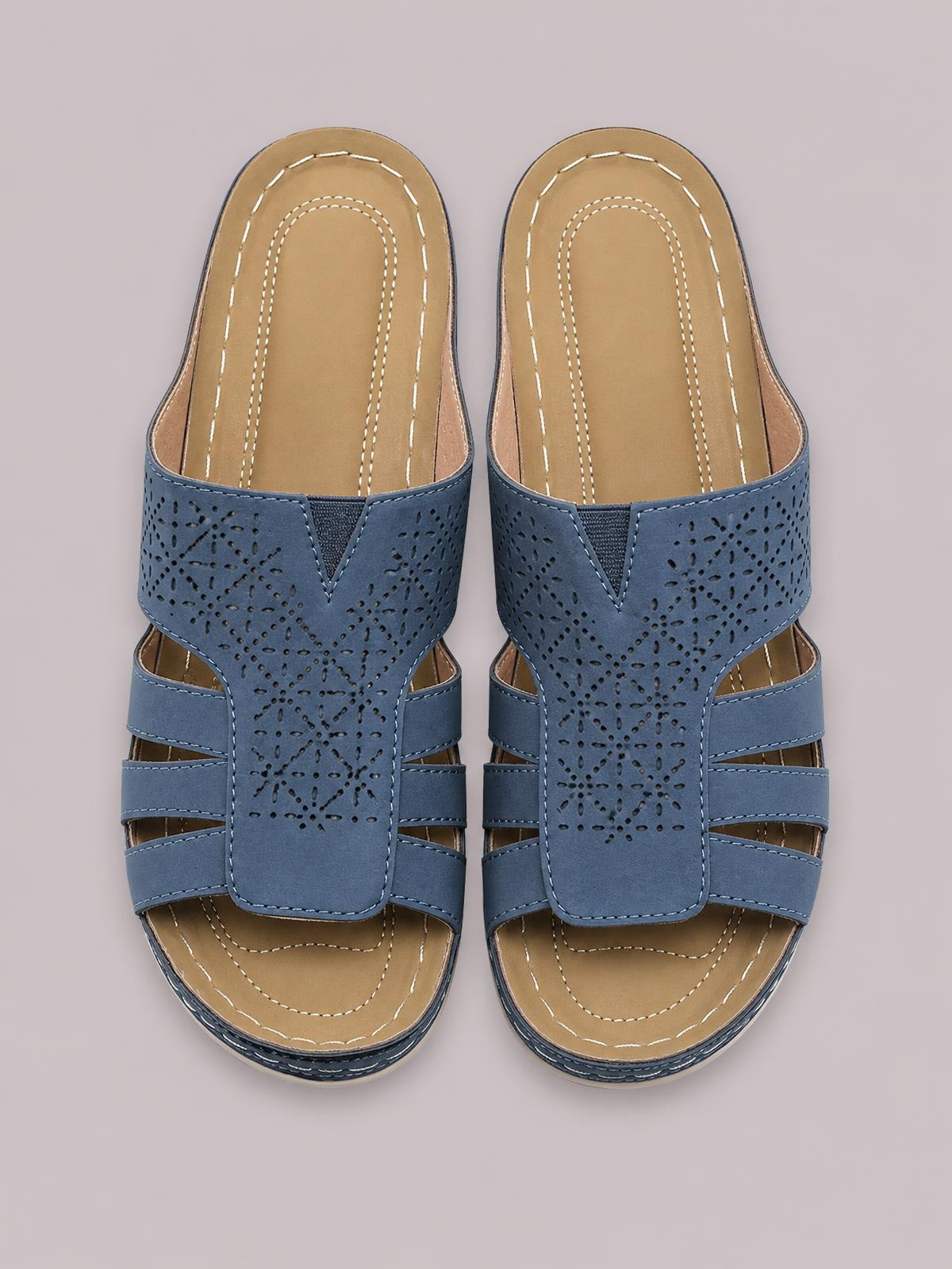 Blue PU leather hollow-out sandals with perforated geometric uppers, open toes, multiple side straps, contrast stitching, and flat rubber soles.
