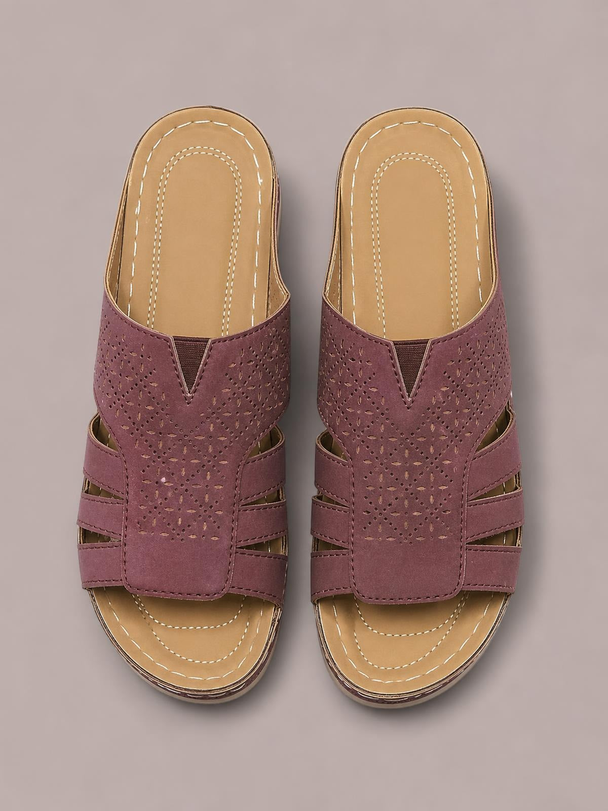 Burgundy PU leather hollow-out wedge sandals with perforated uppers, layered side straps, open toes, stitched tan insoles, and flat rubber soles.