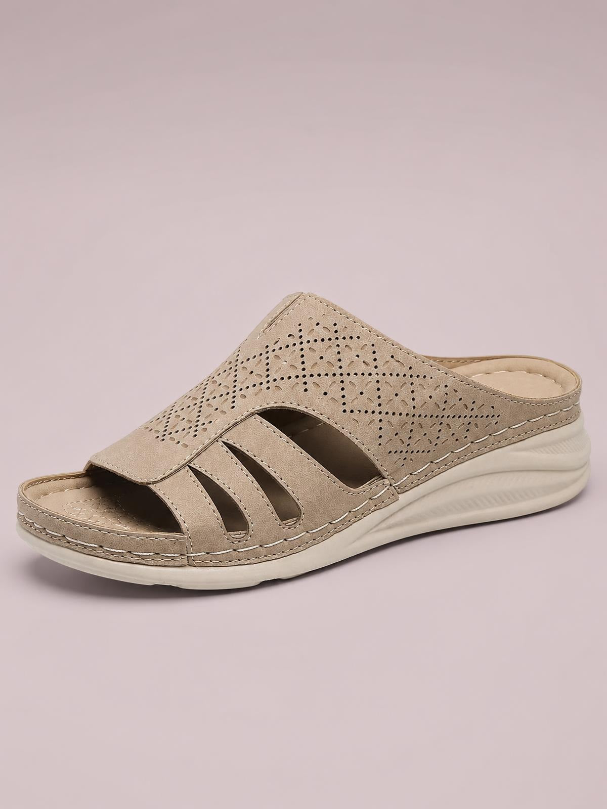 Taupe hollow-out wedge sandals feature an open toe, perforated PU leather upper, cutout straps, and a cushioned rubber sole with stitched construction.