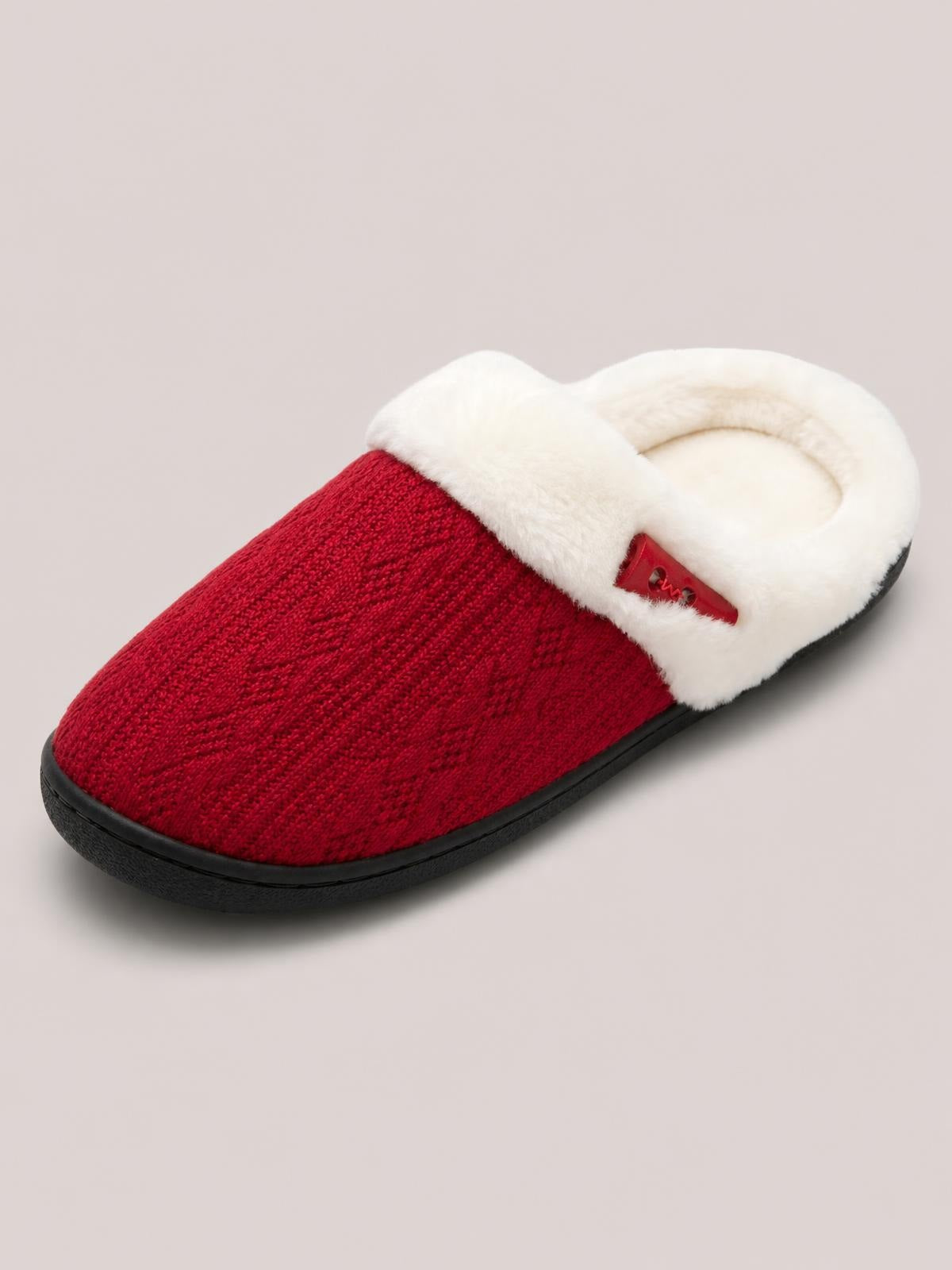 Red furry-texture flat slipper with a plush white lining, red upper, horn-style buckle detail, and a sturdy black rubber sole.