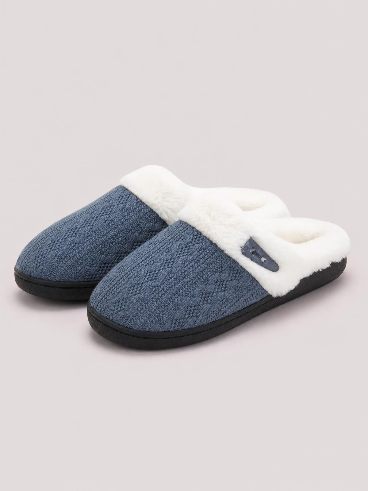 Blue furry-texture flat slippers feature a soft white lining, dark horn-style buckle detail, rounded closed toes, and sturdy black rubber soles.