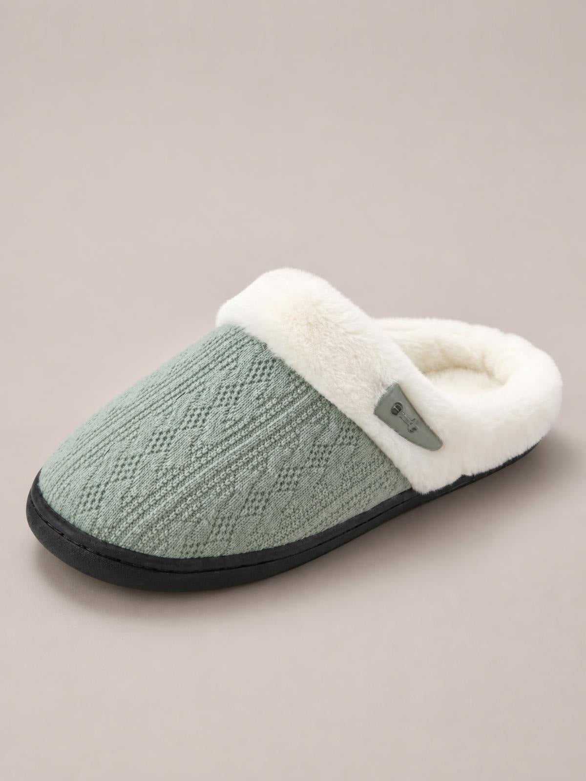 Sage green furry-texture flat slipper with a plush white collar, gray horn-style buckle, closed toe, and sturdy black rubber sole.