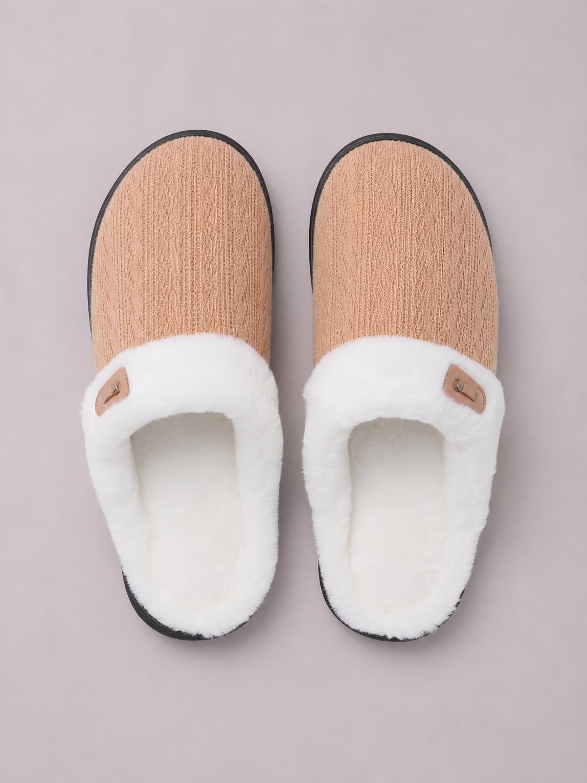 Pair of flat slippers with tan furry-texture uppers, plush white open-back straps, horn buckle accents, and black rubber soles.