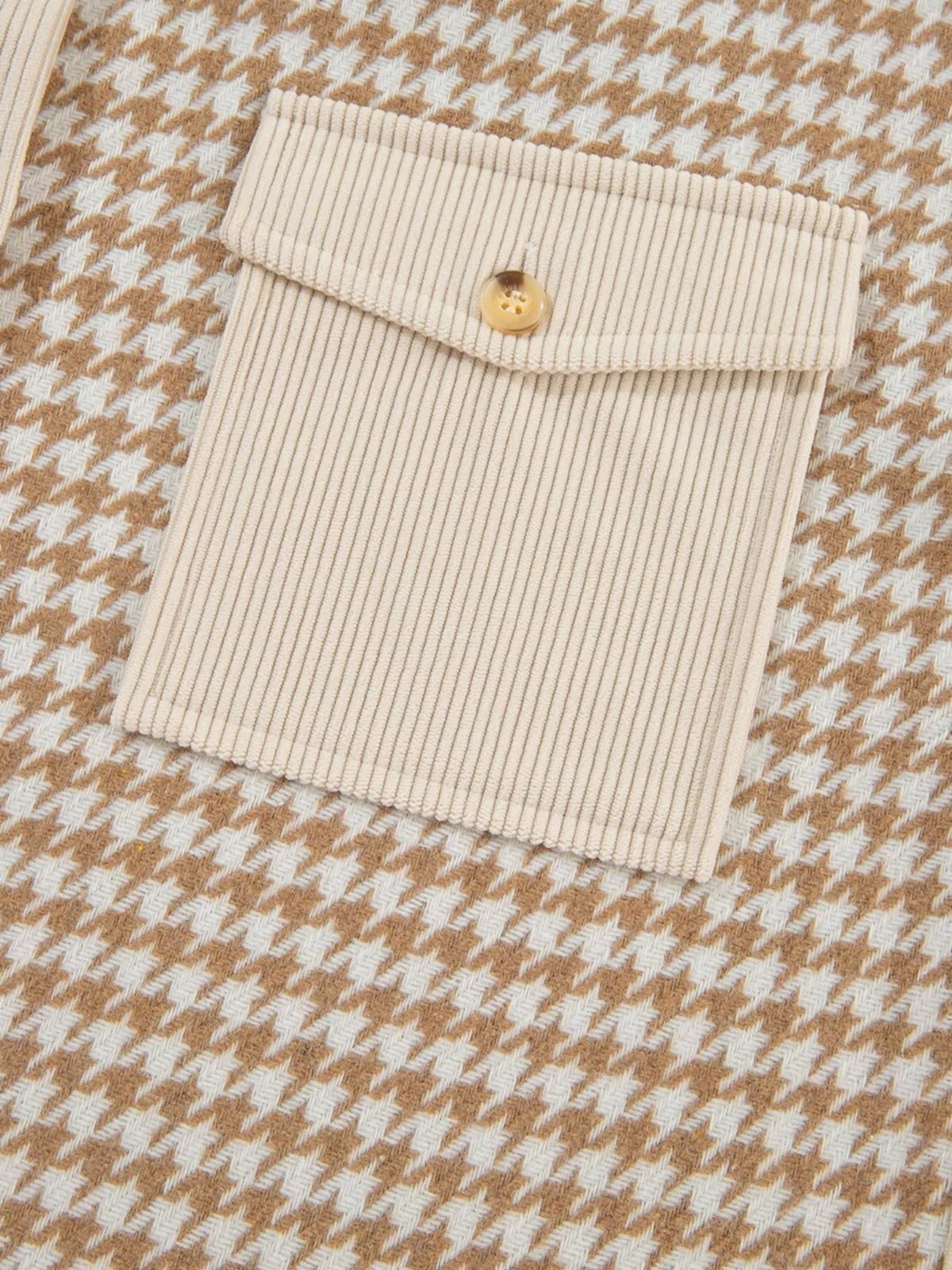 Close-up of a cream and tan houndstooth button-down jacket showing a ribbed corduroy pocket flap with a single button and tailored construction.