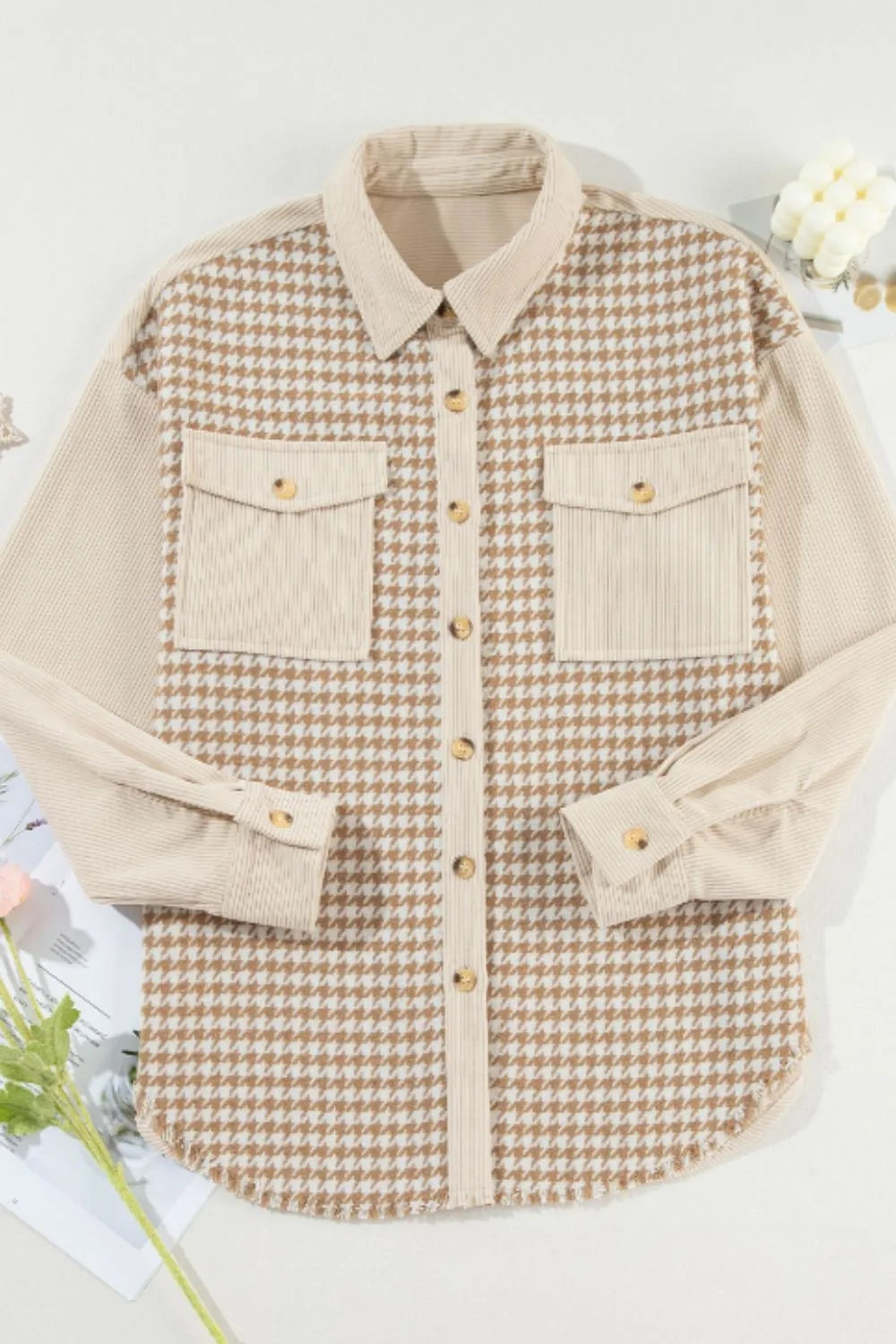 A beige and brown houndstooth button-up jacket with a pointed collar, long sleeves, contrasting textured panels, and two flap pockets.