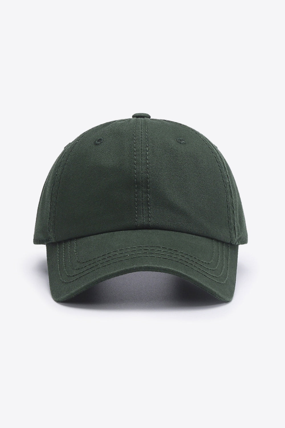 A solid deep green cotton baseball cap with a softly structured crown, curved brim, and neatly defined tonal stitching for a classic silhouette.