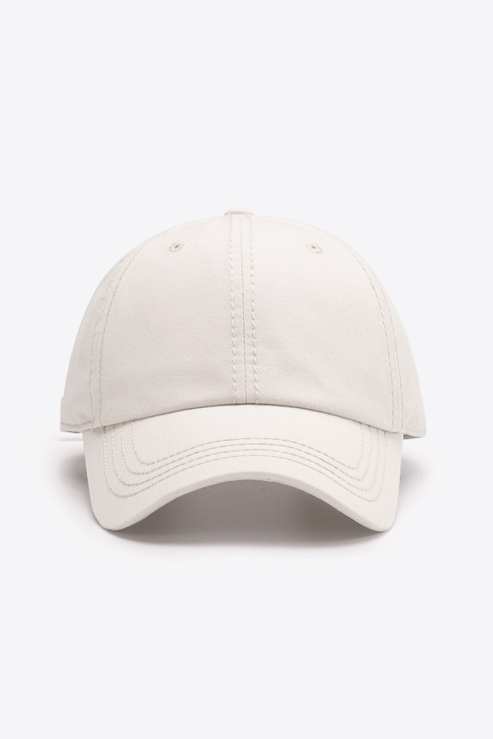 Solid cream cotton baseball cap with a softly structured crown, curved brim, and neatly defined tonal stitching for a polished everyday silhouette.