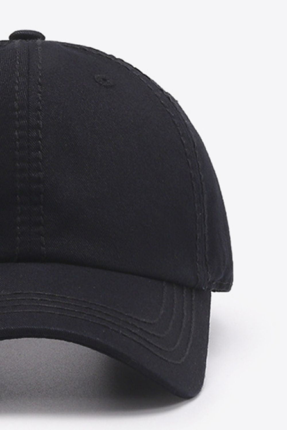 Black cotton baseball cap with a softly structured crown, curved brim, solid finish, and neatly defined tonal stitching for a polished everyday silhouette.
