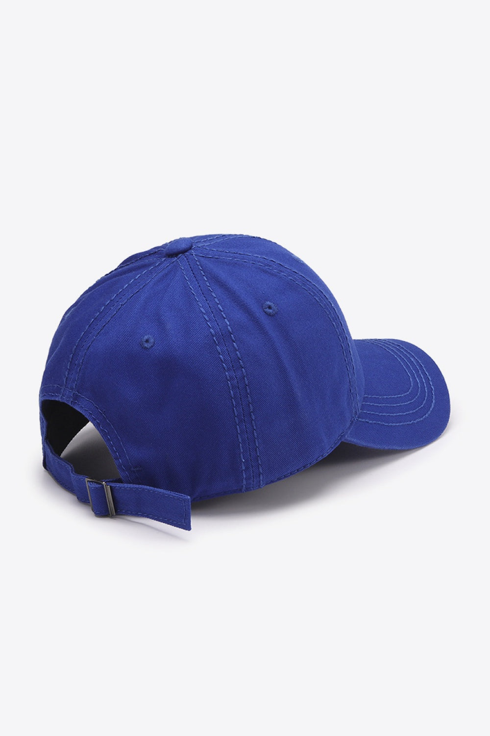A solid royal blue cotton baseball cap with a softly structured crown, curved brim, stitched panels, and an adjustable rear strap.