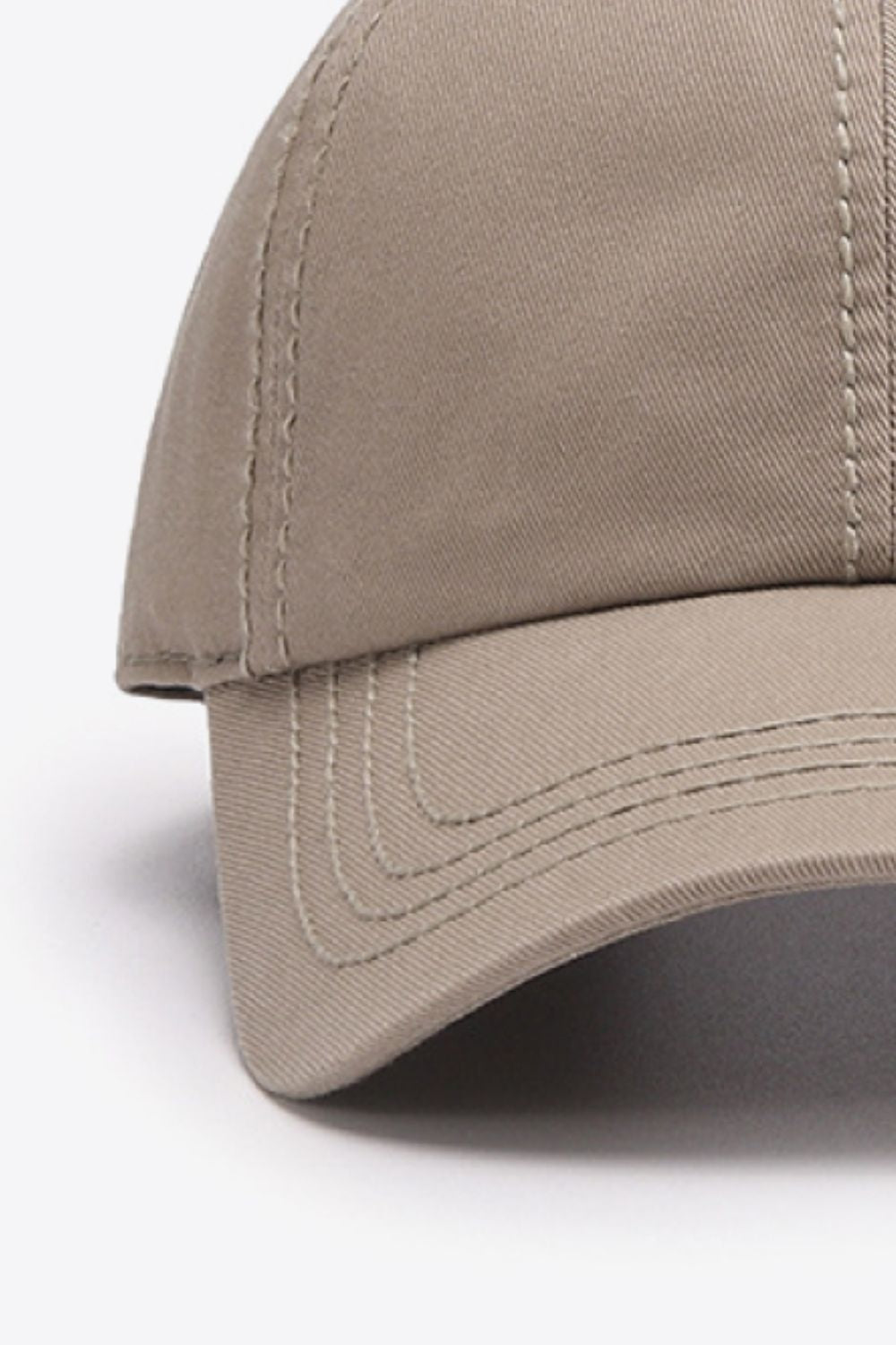 Solid taupe cotton baseball cap with a softly structured crown, curved brim, and neatly defined tonal stitching for a classic, polished silhouette.