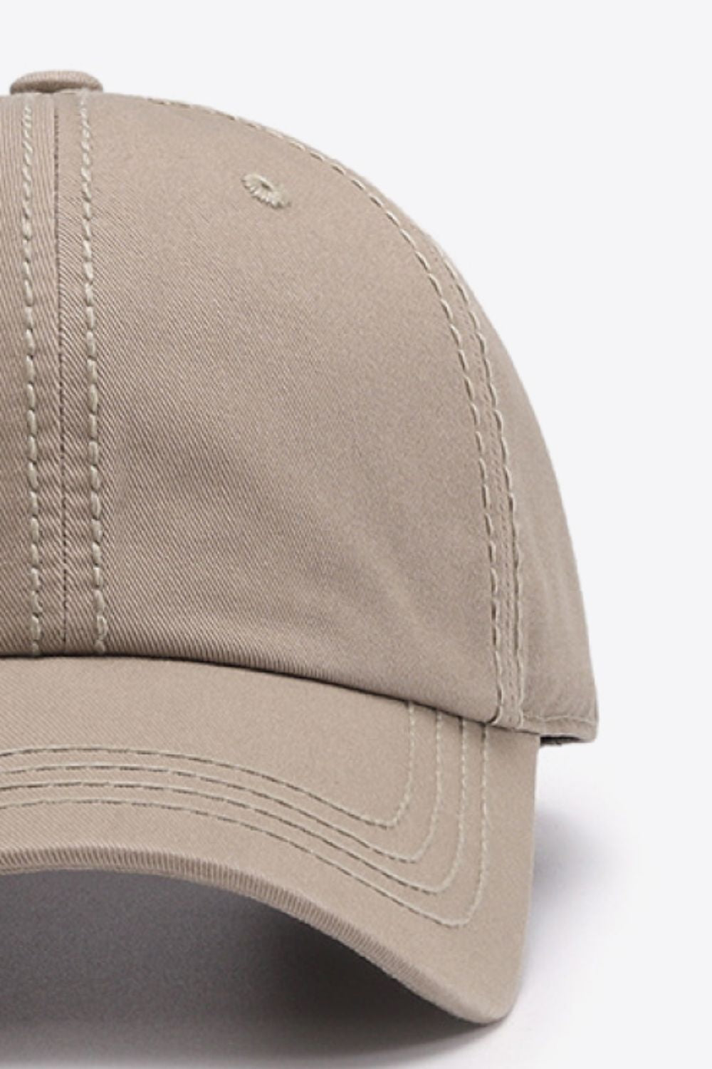 The In A Pretty World baseball cap features a taupe cotton crown, curved brim, softly structured six-panel silhouette, and contrasting double-stitched seams.