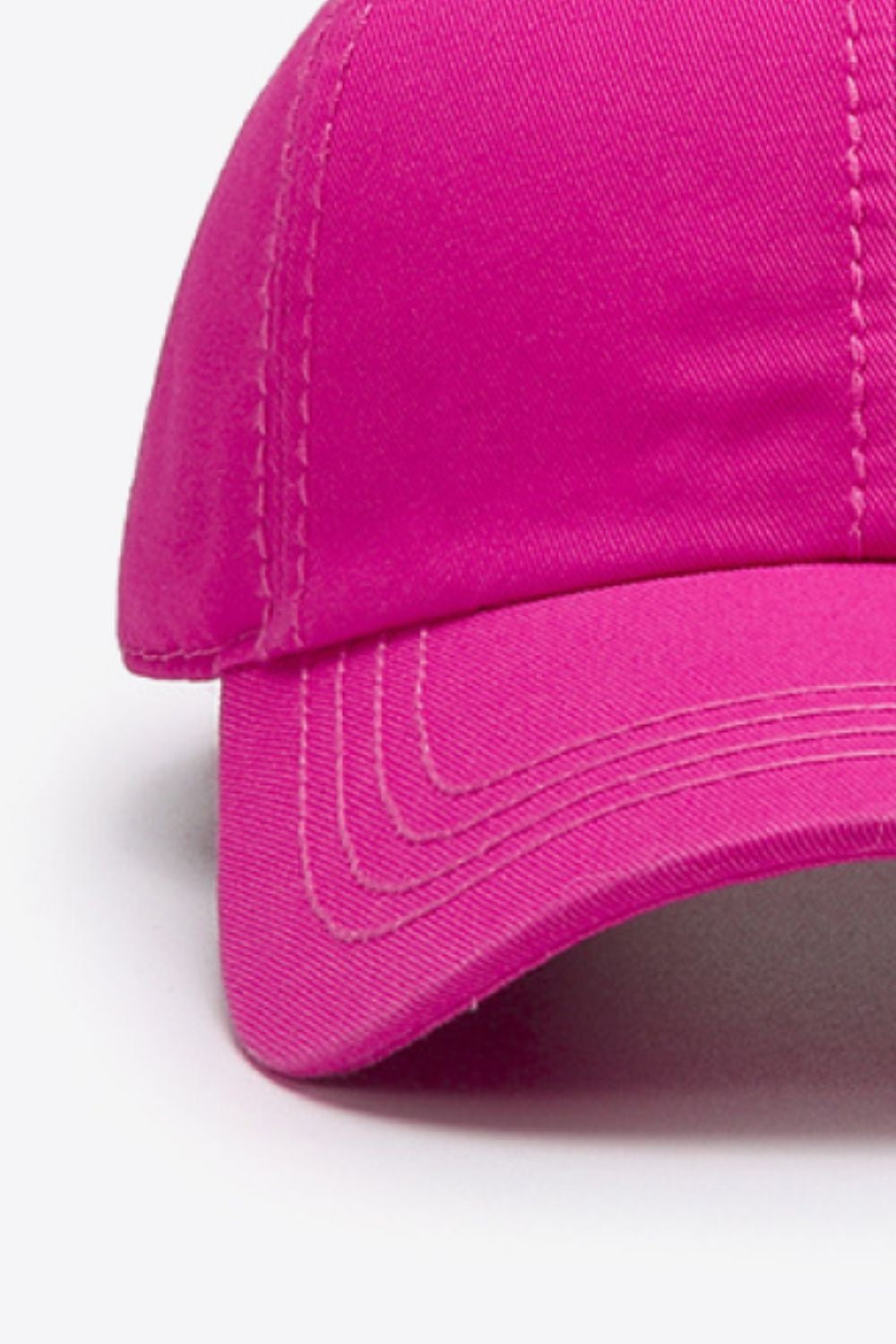 A bright pink solid cotton baseball cap features a softly structured crown, curved brim, and neatly defined tonal stitching for a polished casual silhouette.