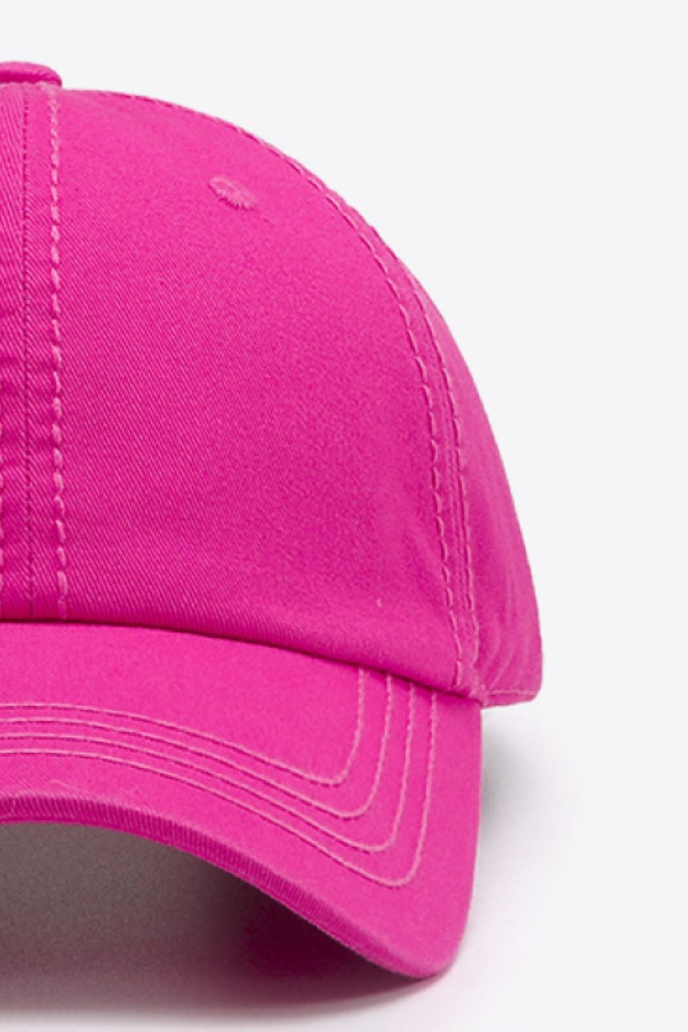 A bright pink solid cotton baseball cap features a softly structured crown, curved brim, and neatly defined contrasting stitching for a polished casual silhouette.