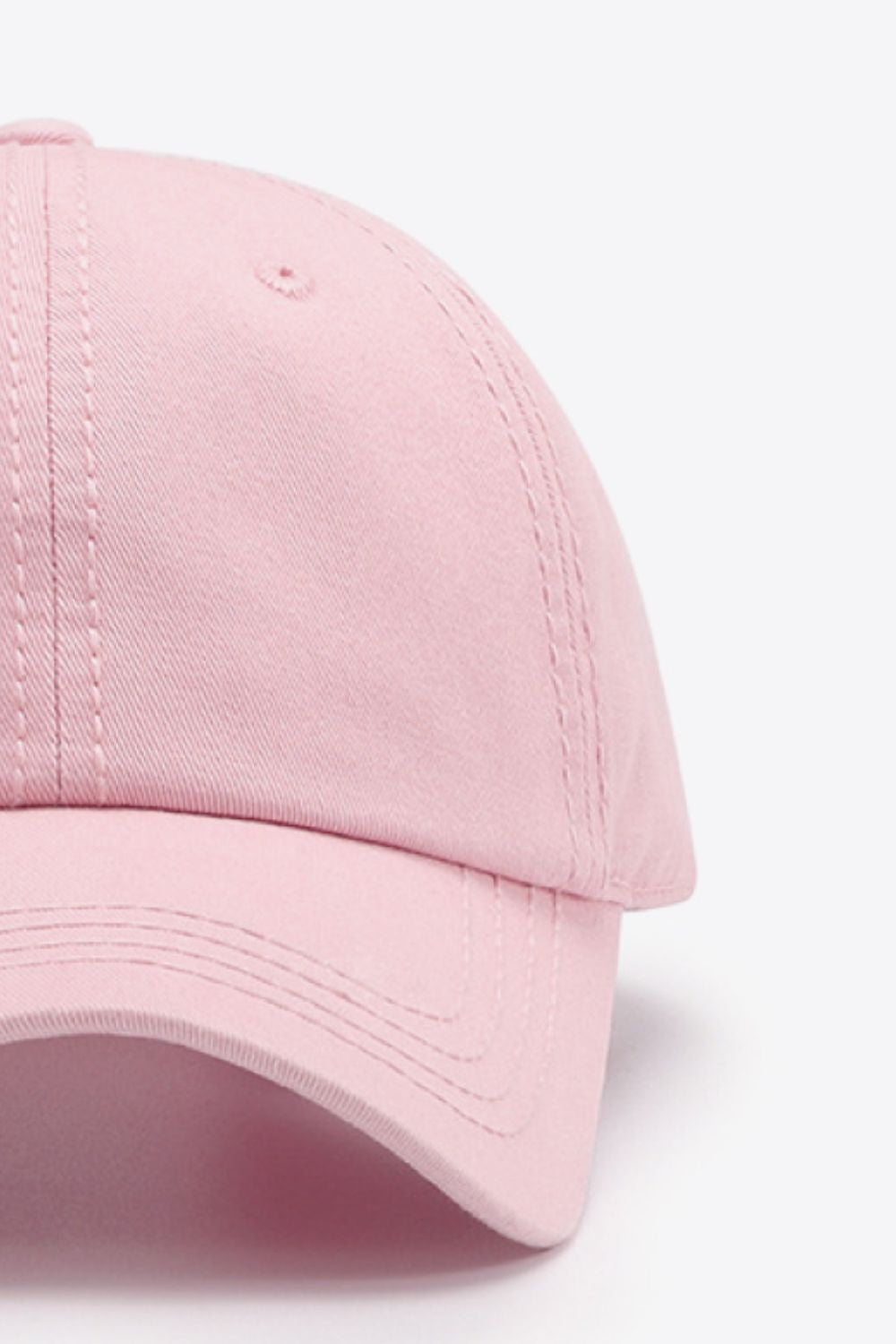 The In A Pretty World Baseball Cap is a solid pink cotton style with a softly structured crown, curved brim, and neatly defined stitching.