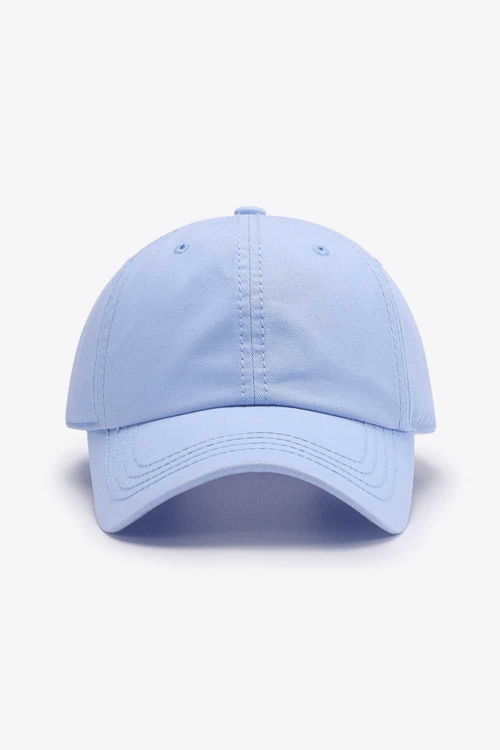 A light blue solid cotton baseball cap with a softly structured crown, curved brim, and neatly defined panel stitching for a polished everyday silhouette.
