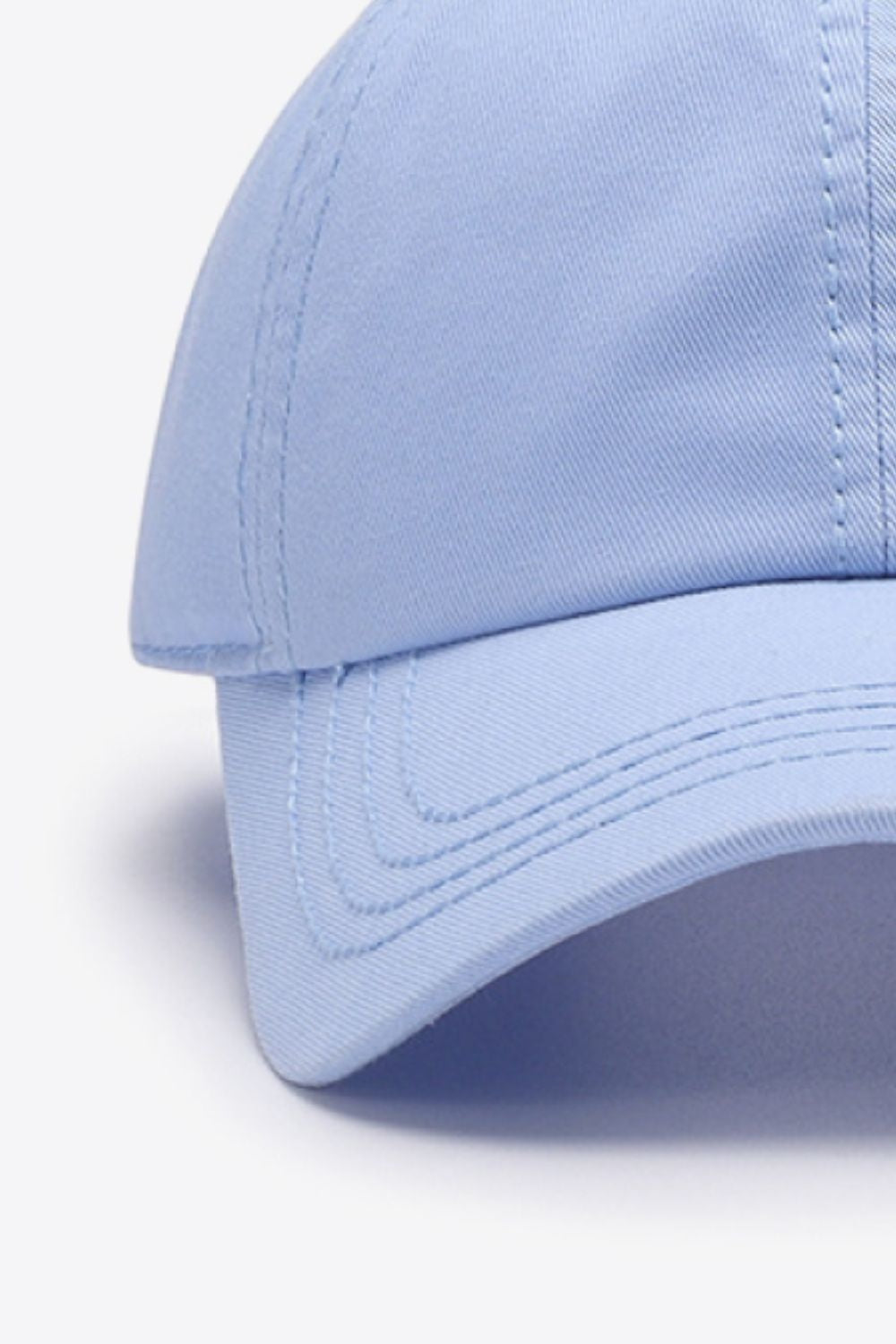Light blue solid cotton baseball cap with a softly structured crown, curved brim, and neatly defined tonal stitching for a polished casual silhouette.