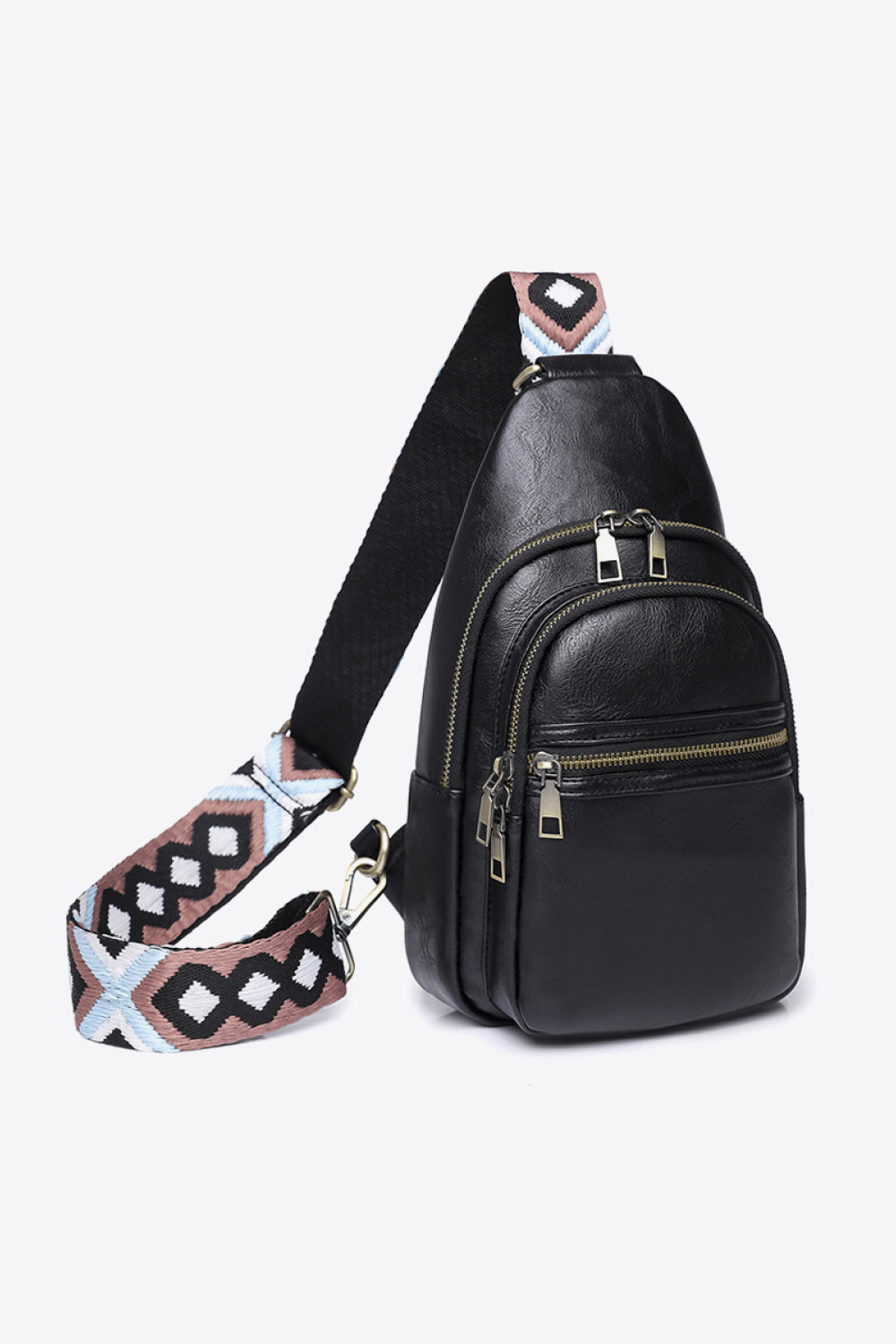 Black PU leather sling bag with a compact vertical silhouette, layered zip compartments, metal pulls, and a wide patterned adjustable strap.