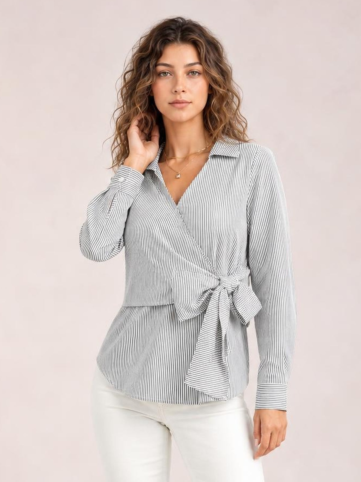 Model wearing a gray-and-white striped blouse with a Johnny collar, long regular sleeves, curved hem, and a bow-tie waist creating a flattering silhouette.