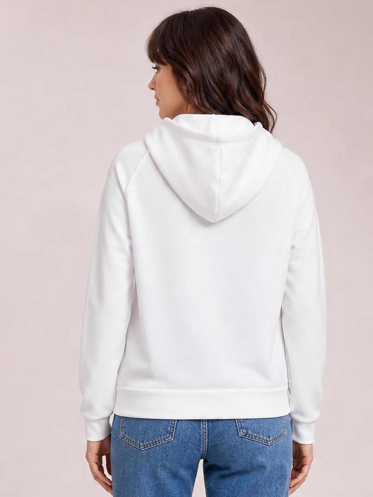 A model wears a white hoodie with a relaxed silhouette, visible raglan sleeves, contrast stitching, and a structured hood, shown from the back.