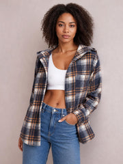 Model wears a navy, tan, and white plaid button-up hooded jacket with long sleeves, visible buttons and pockets, and a relaxed silhouette.