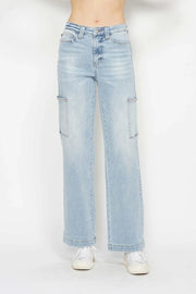 Model wearing light-wash JuBlue high-waist straight cargo jeans with front and side utility pockets, belt loops, button closure, and wide straight legs.