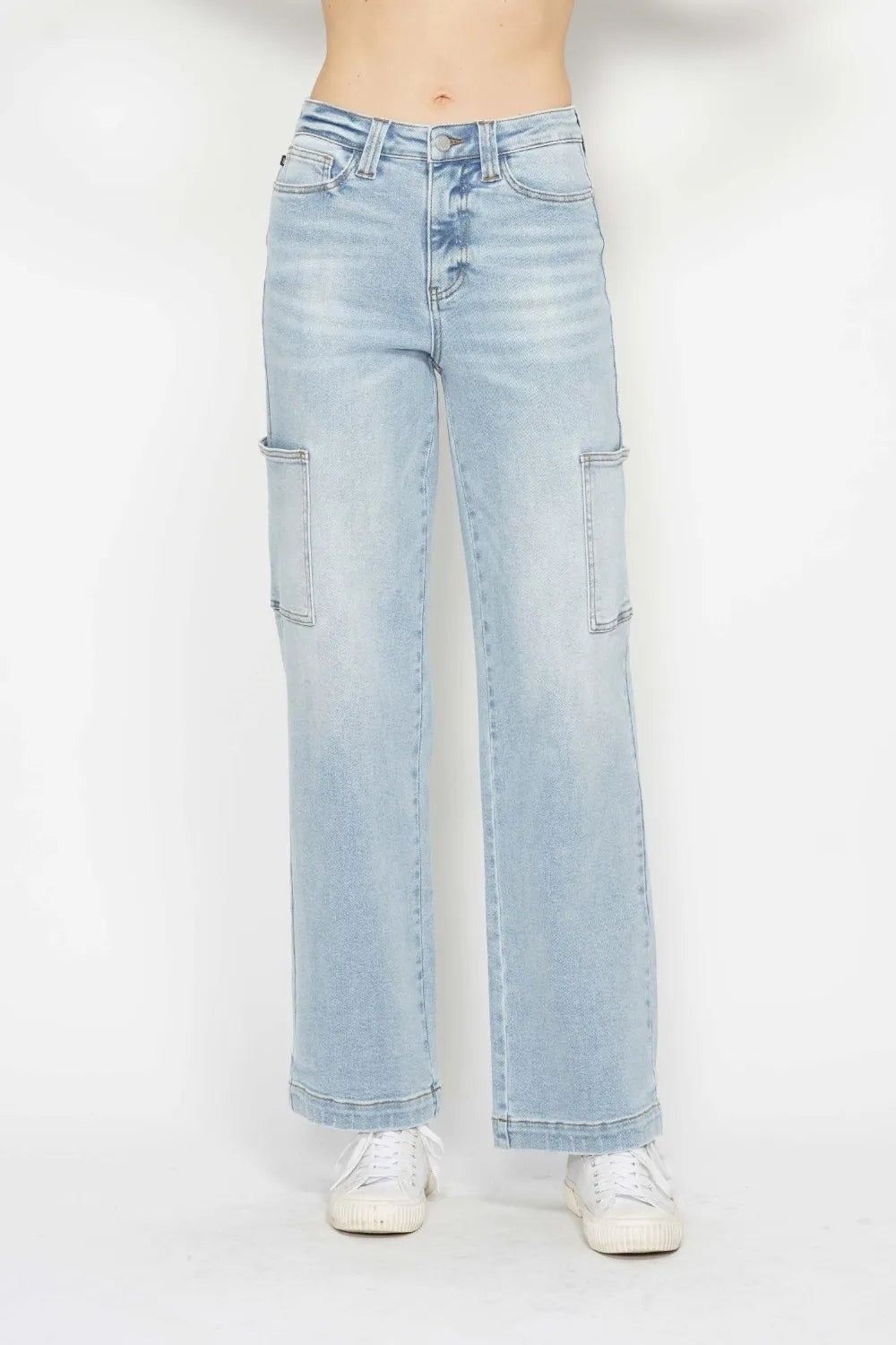 Model wearing light-wash JuBlue high-waist straight cargo jeans with front and side utility pockets, belt loops, button closure, and wide straight legs.