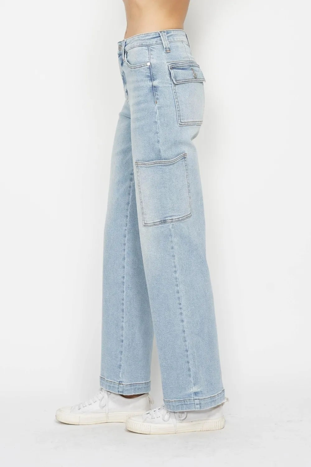 Model in profile wears light-wash JuBlue high waist straight cargo jeans with belt loops, contrast seams, multiple flap pockets, and relaxed straight legs.