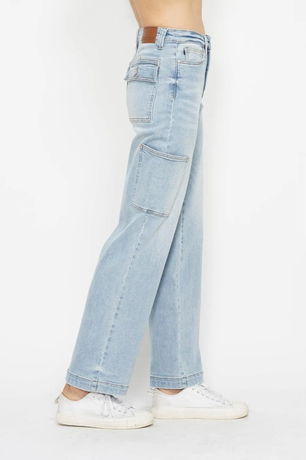 Model shown in side profile wearing light-washed JuBlue high waist straight cargo jeans with belt loops, multiple utility pockets, and a relaxed straight-leg silhouette.