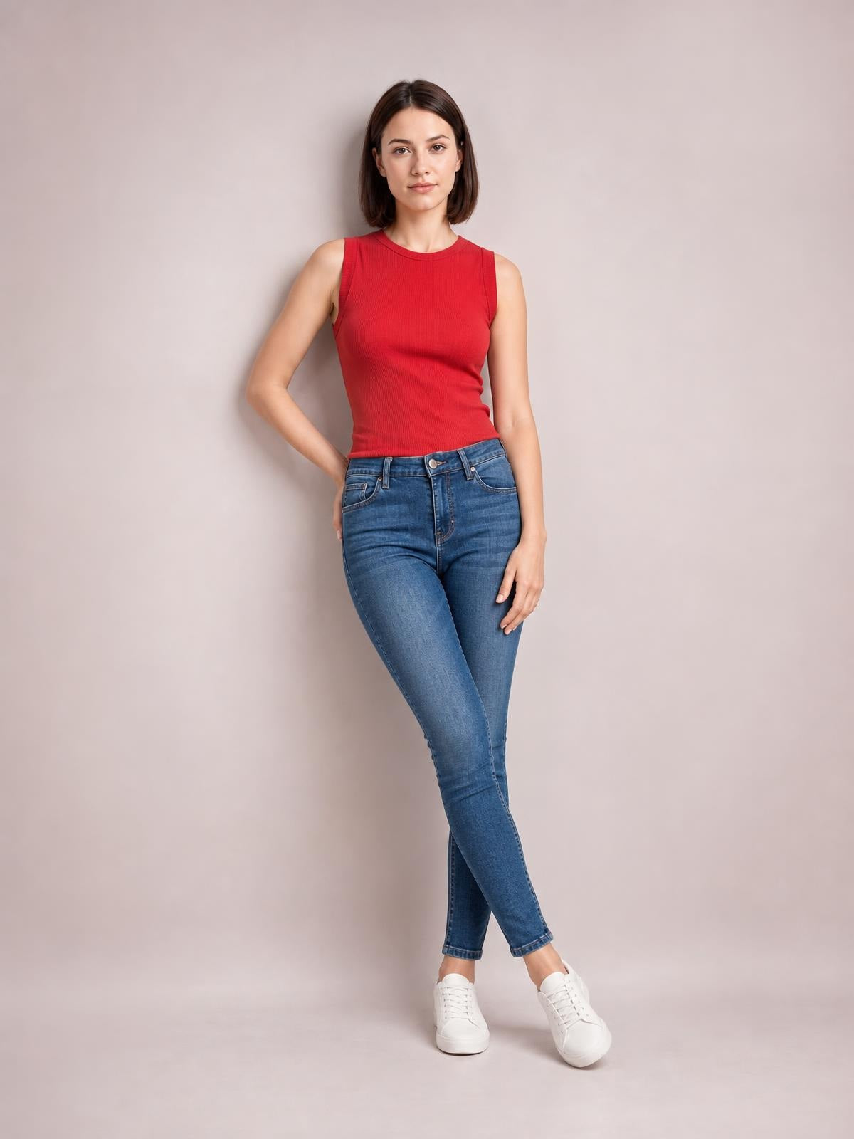 Model poses in blue washed thermal skinny jeans with a fitted silhouette, button closure, front pockets, and tapered legs.