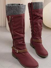 Burgundy knee-high slouch boots feature gray knit cuffs, low heels, side zippers, buckled ankle straps, and a rounded toe in suede with rubber soles.