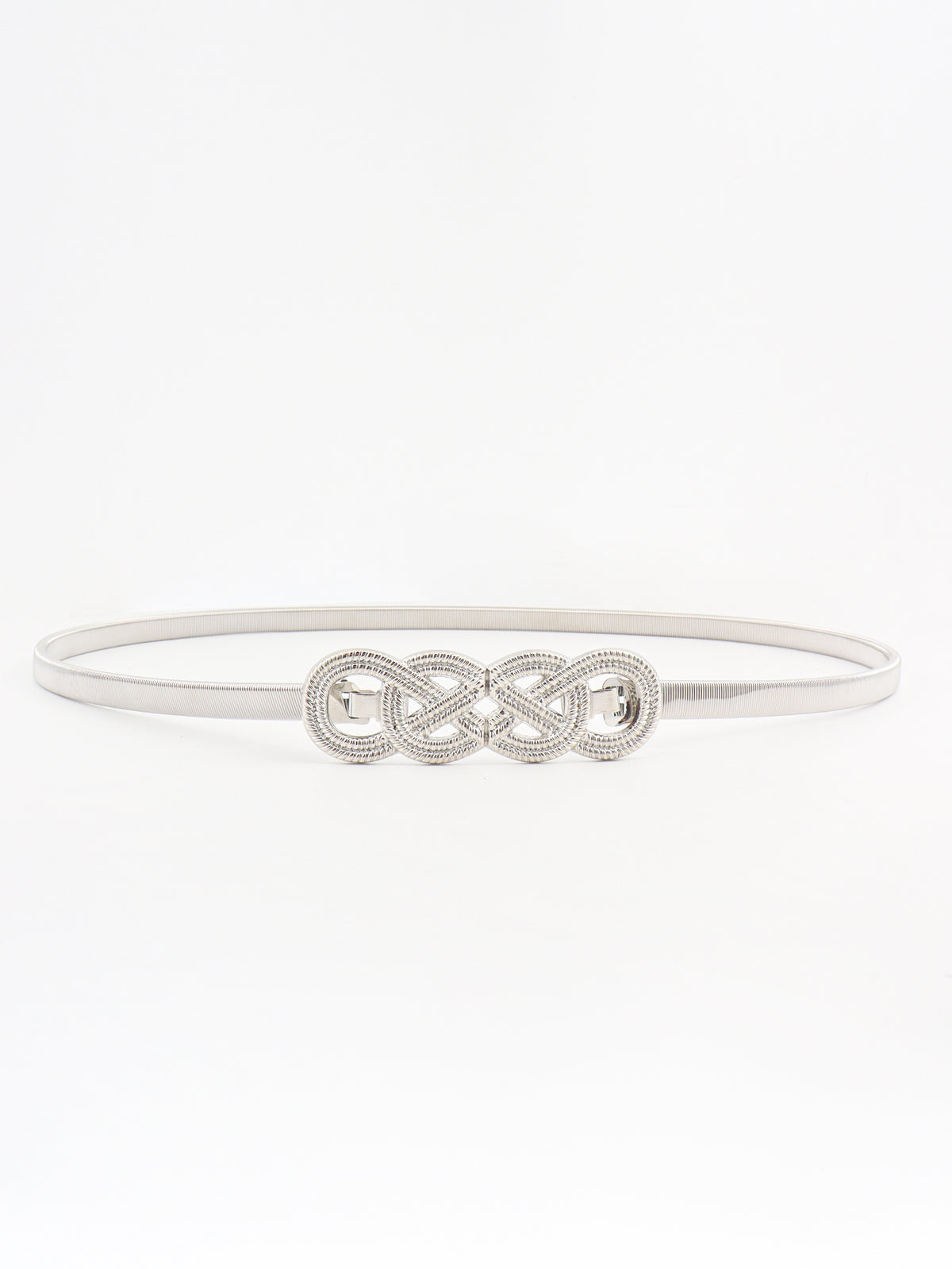 Slim silver-tone metal belt with a subtly textured band and ornate interlocking knot buckle, showcasing a refined, sculptural waist-defining silhouette.