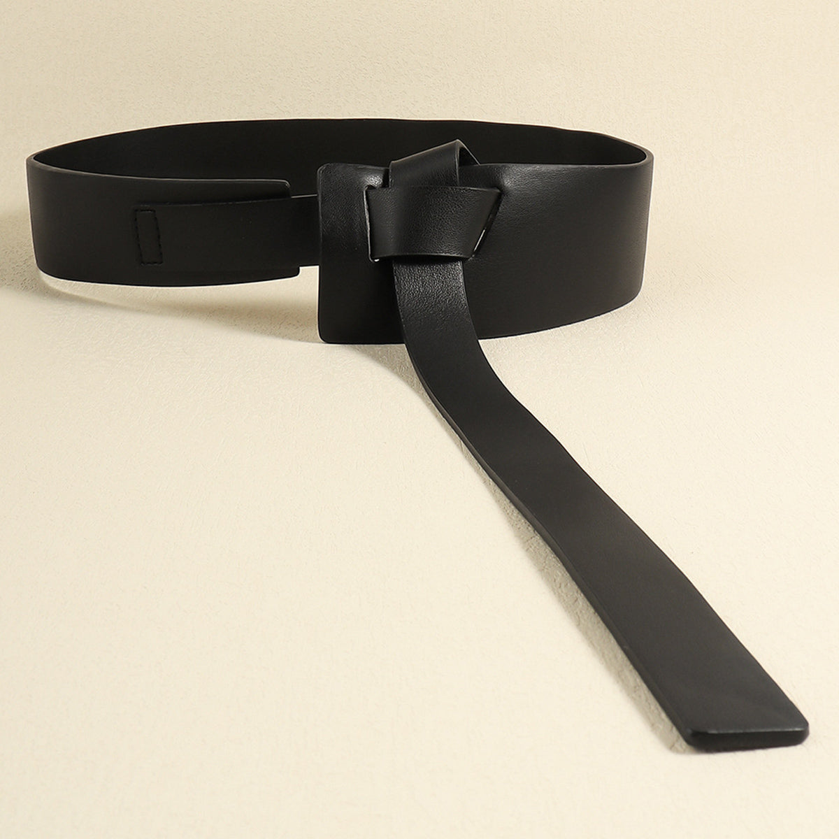 Black PU Knot Detail Belt with a broad wraparound silhouette, dimensional front knot, and long extended strap for a sculptural draped finish.