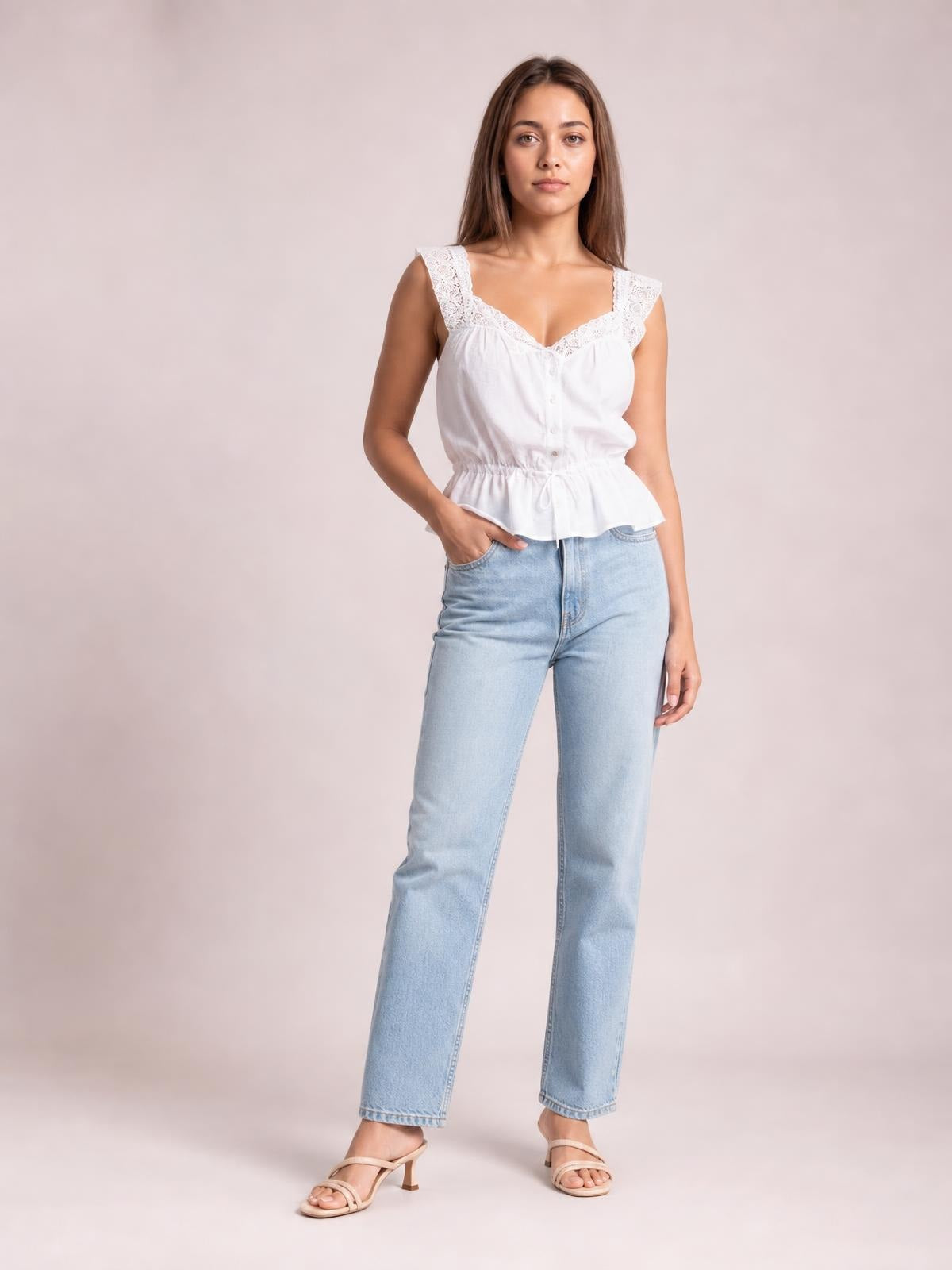 A model poses in a white lace detail tank with buttoned front, scalloped straps, adjustable drawstring waist, and a softly flared peplum silhouette.