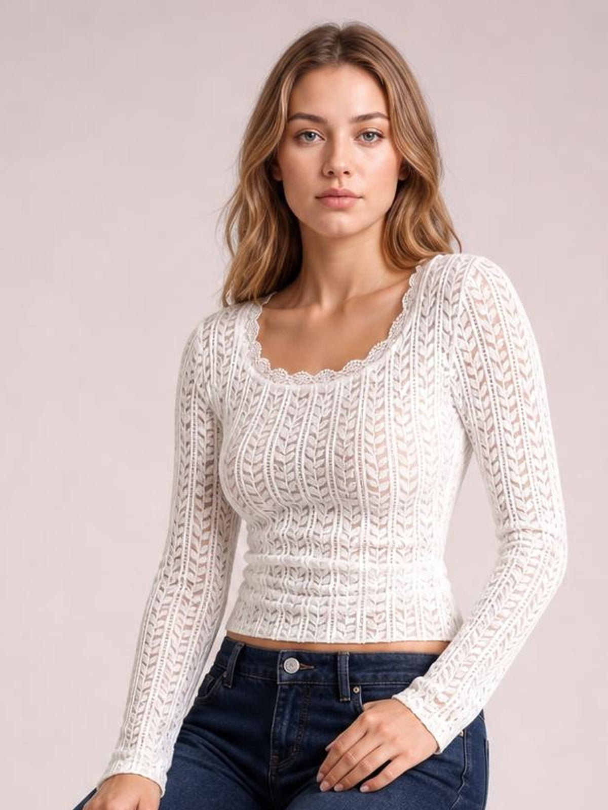 A model wears a white semi-sheer lace detail long sleeve T-shirt with a scalloped scoop neckline, fitted silhouette, and textured vertical openwork pattern.