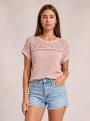 Model wears a dusty pink waffle knit short sleeve top with lace patchwork across the yoke, crew neckline, rolled cuffs, and a relaxed silhouette.