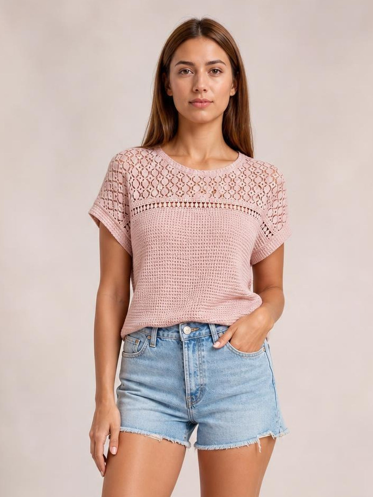 Model wears a dusty pink waffle knit short sleeve top with lace patchwork across the yoke, crew neckline, rolled cuffs, and a relaxed silhouette.