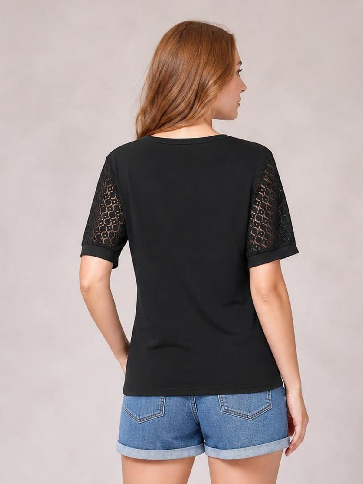 Model shown from the back in a black Lace Short Sleeve T-Shirt with semi-sheer openwork lace sleeves and a relaxed, straight silhouette.