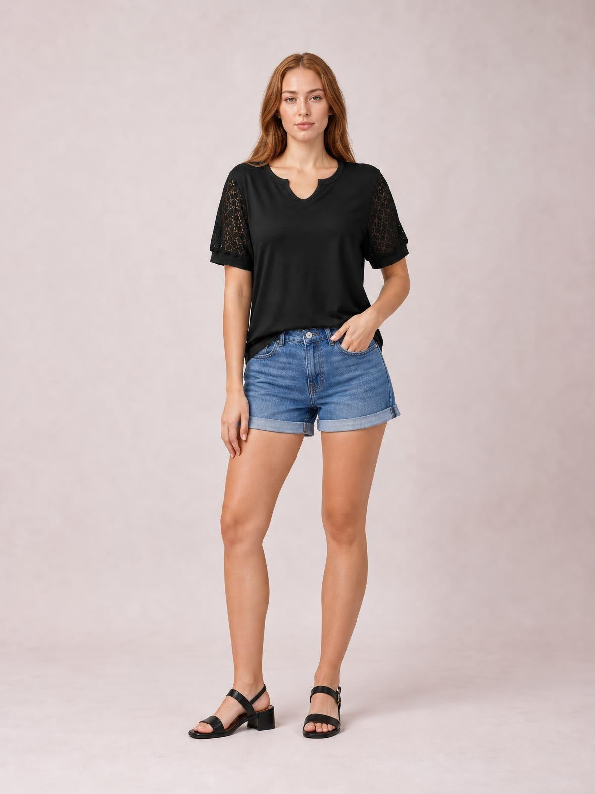 Model poses in a black Lace Short Sleeve T-Shirt with semi-sheer openwork sleeves, a notched neckline, and a relaxed straight silhouette.