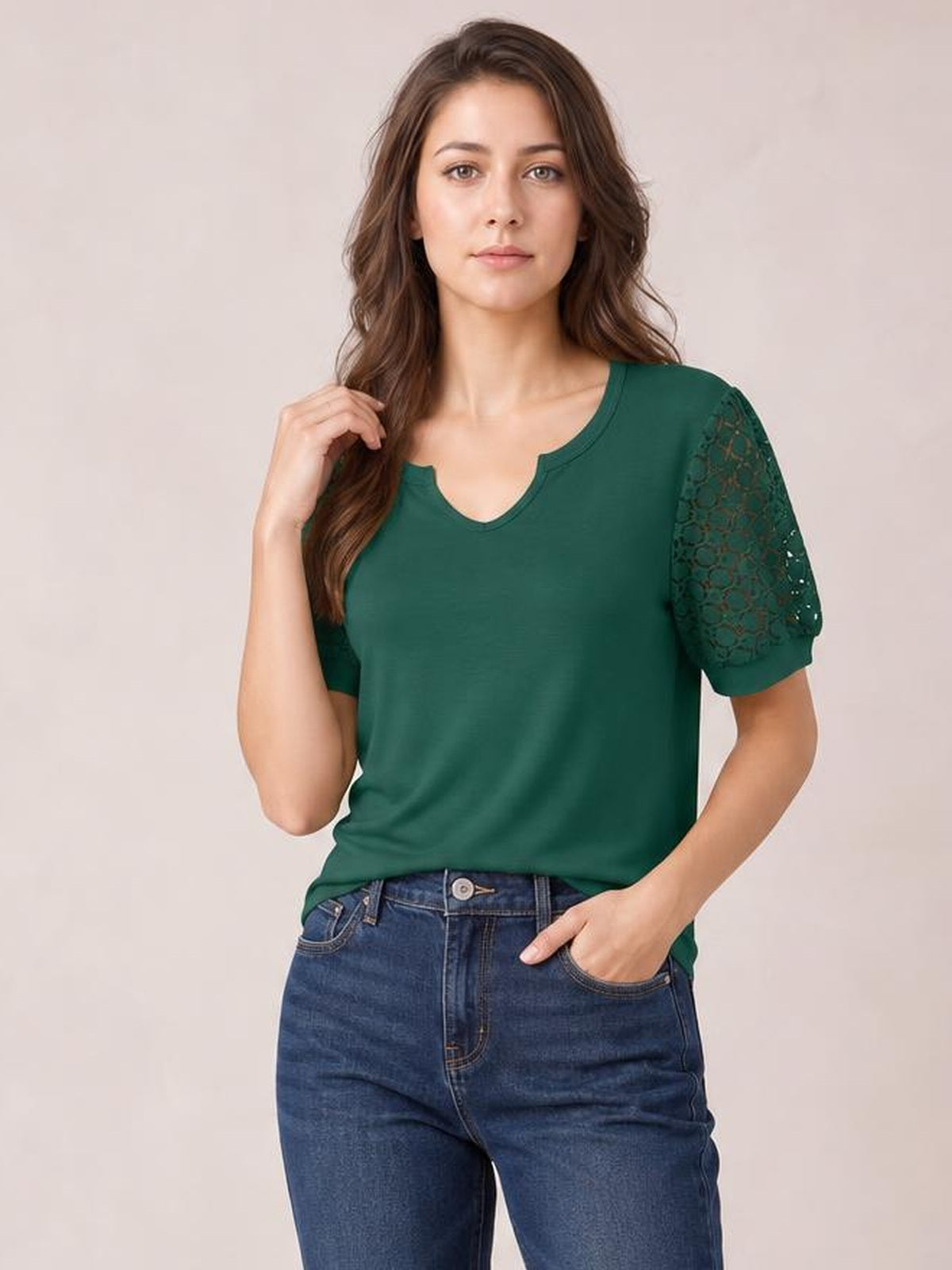 Model wears a dark green lace short sleeve T-shirt with openwork sleeves, a notched scoop neckline, semi-sheer detailing, and a relaxed silhouette.