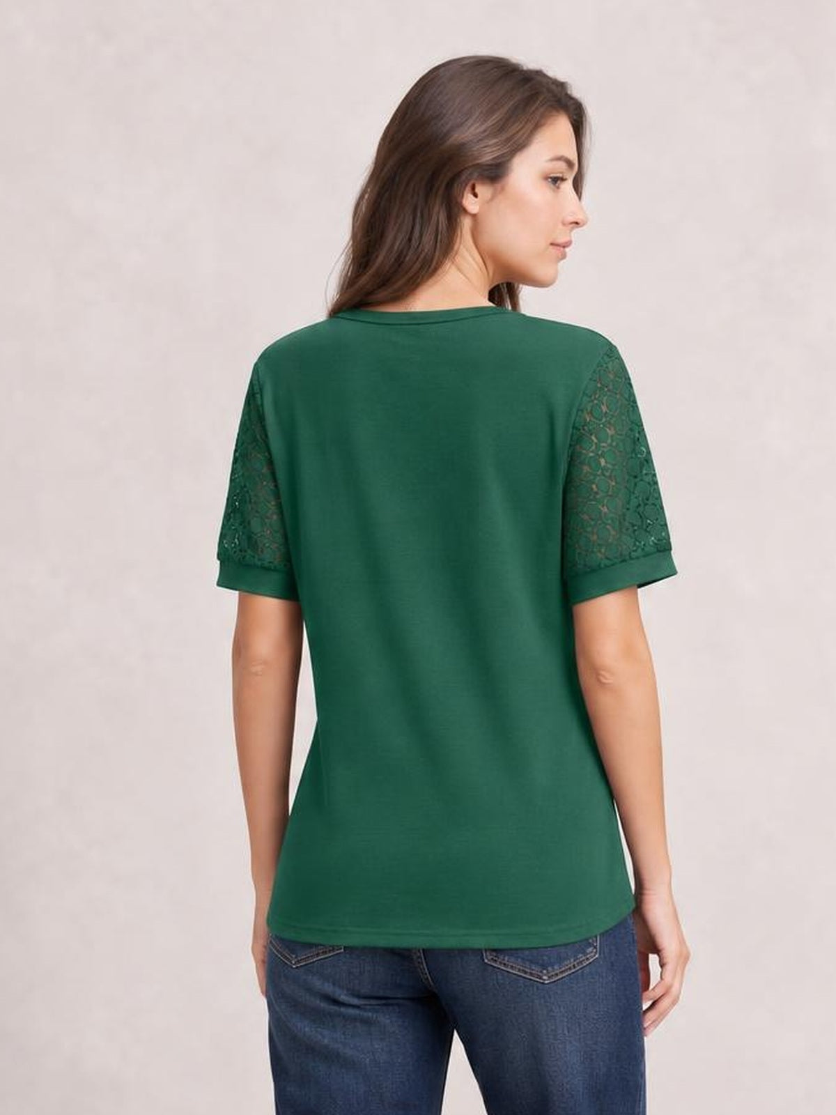 Model shown from the back in a forest green lace short sleeve T-shirt with openwork sleeves, a straight relaxed silhouette, and slightly rounded hem.