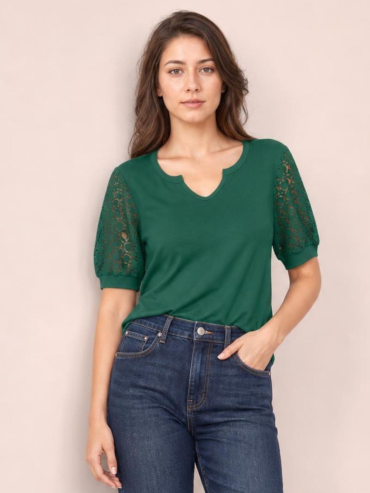 A model wears a forest green lace short sleeve T-shirt with semi-sheer openwork sleeves, a notched neckline, and a relaxed silhouette.