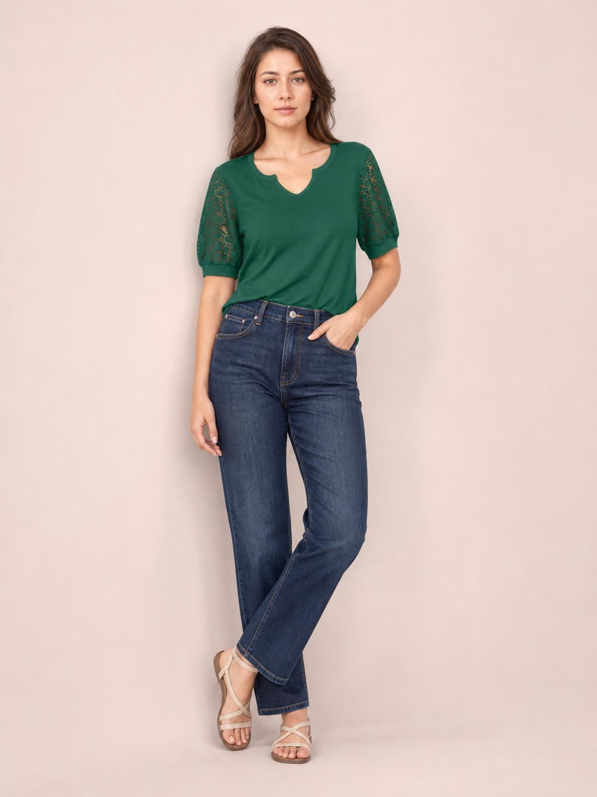 Model poses in a forest green lace short sleeve T-shirt with semi-sheer openwork sleeves, a relaxed silhouette, and a notched neckline.