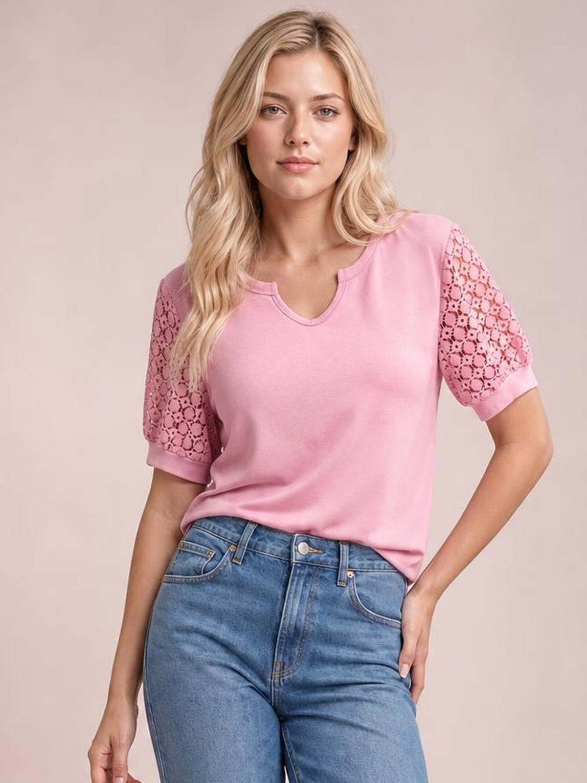 Model wearing a pink lace short sleeve T-shirt with semi-sheer openwork sleeves, cuffed hems, a V-notch neckline, and a relaxed silhouette.