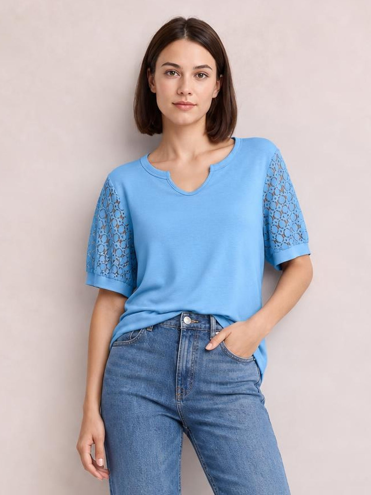 Model poses with one hand in her pocket, wearing a sky-blue Lace Short Sleeve T-Shirt with semi-sheer openwork sleeves, a notched neckline, and a relaxed silhouette.