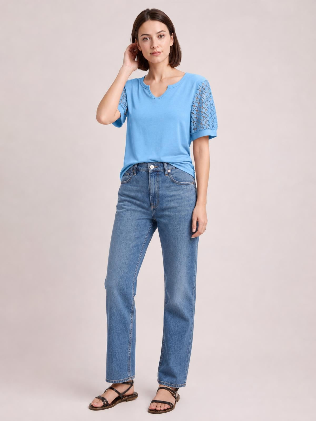 Model poses in a blue Lace Short Sleeve T-Shirt with semi-sheer openwork lace sleeves, a relaxed silhouette, and a notched neckline.